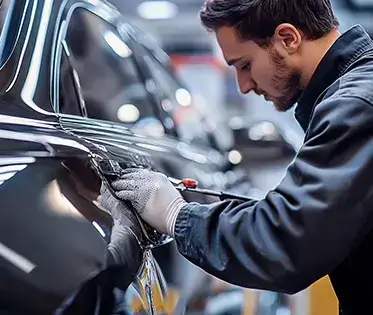 Technician repairing a car in the shop.